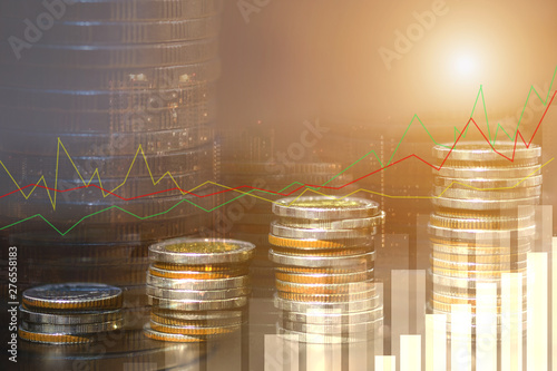 Financial investment concept, Double exposure of city night and stack of coins for finance investor, Forex trading candlestick chart economic , ECN Digital economy, business background.