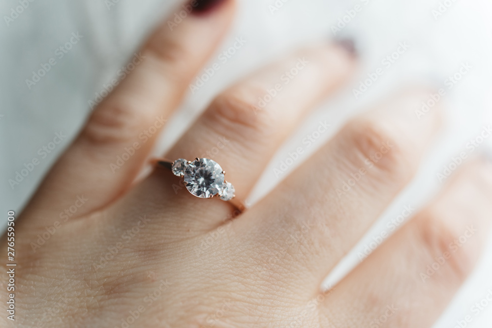 Close up of a womans hand wearing an engagement ring Close up of a womans hand wearing an engagement ring