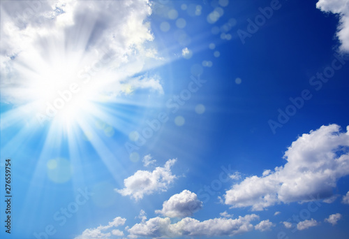 Beautiful shiny blue sky cloudscape image with sun and beam of light © jokerpro