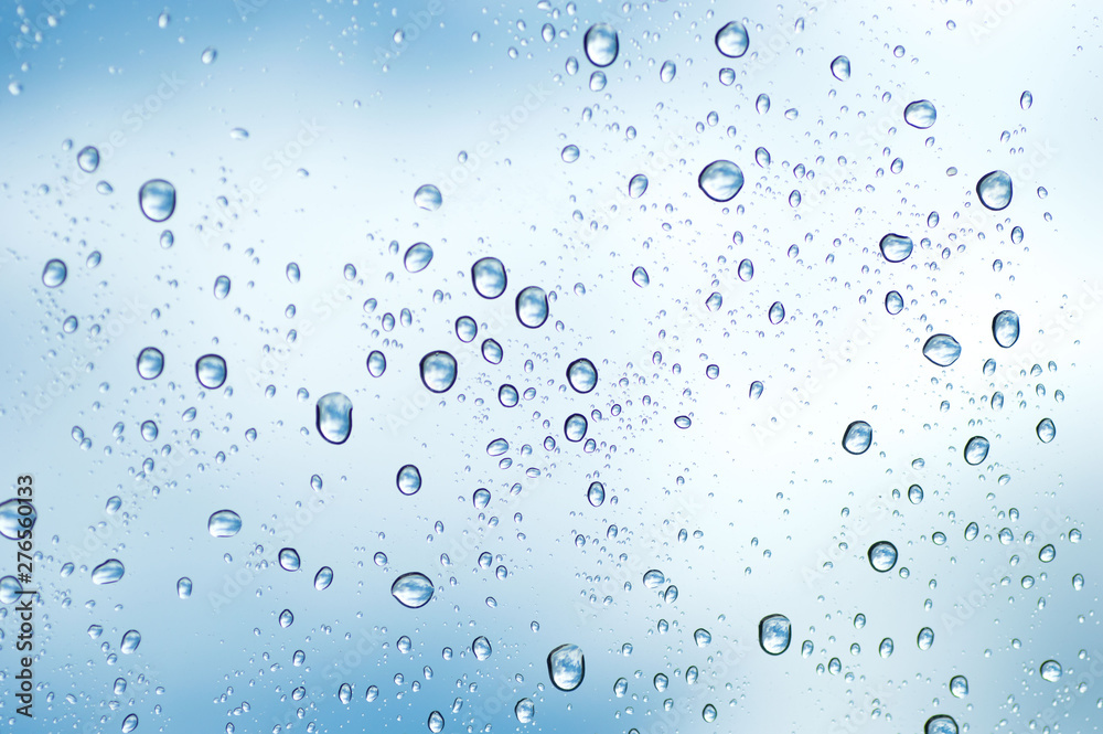 Water drops of rain on blue glass background Water drops of rain on blue glass background