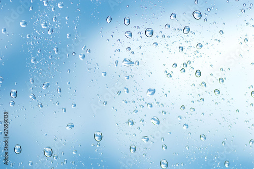 Water drops of rain on blue glass background