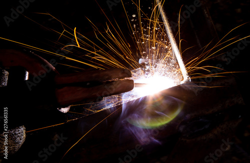 Sparks from welding at a construction site as a background