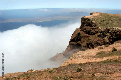 clouds pushing against the mountains on the island of Lanzarote photo