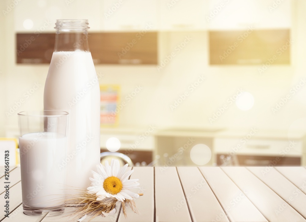 Glass of milk and bottle on  background