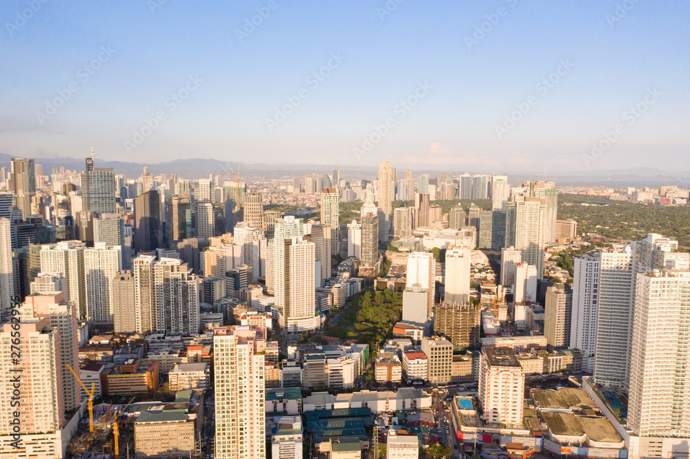 Cityscape of Makati, the business center of Manila, view from above. Asian metropolis in the morning, top view. Skyscrapers and residential neighborhoods, the capital of the Philippines. Modern city.