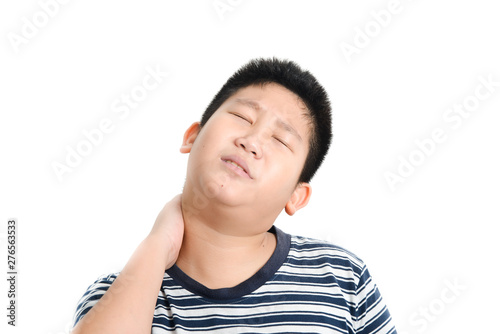 Young Asian preteen boy having shoulder or neck pain.
