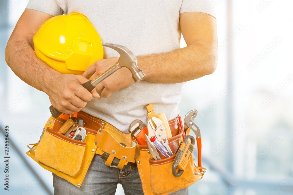 Worker with a tool belt. Isolated over white background. - obrazy, fototapety, plakaty 