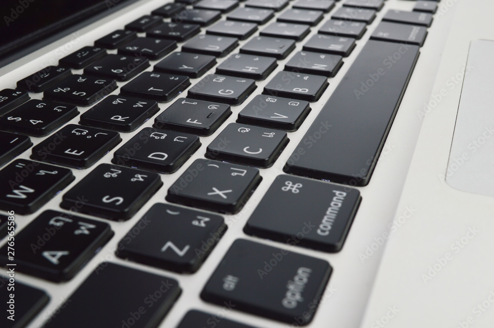 Close up laptop keyboard with Thai English language of a modern laptop Close up laptop keyboard with Thai English language of a modern laptop