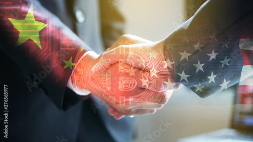 Businessman shake hand over United States of America and China flag