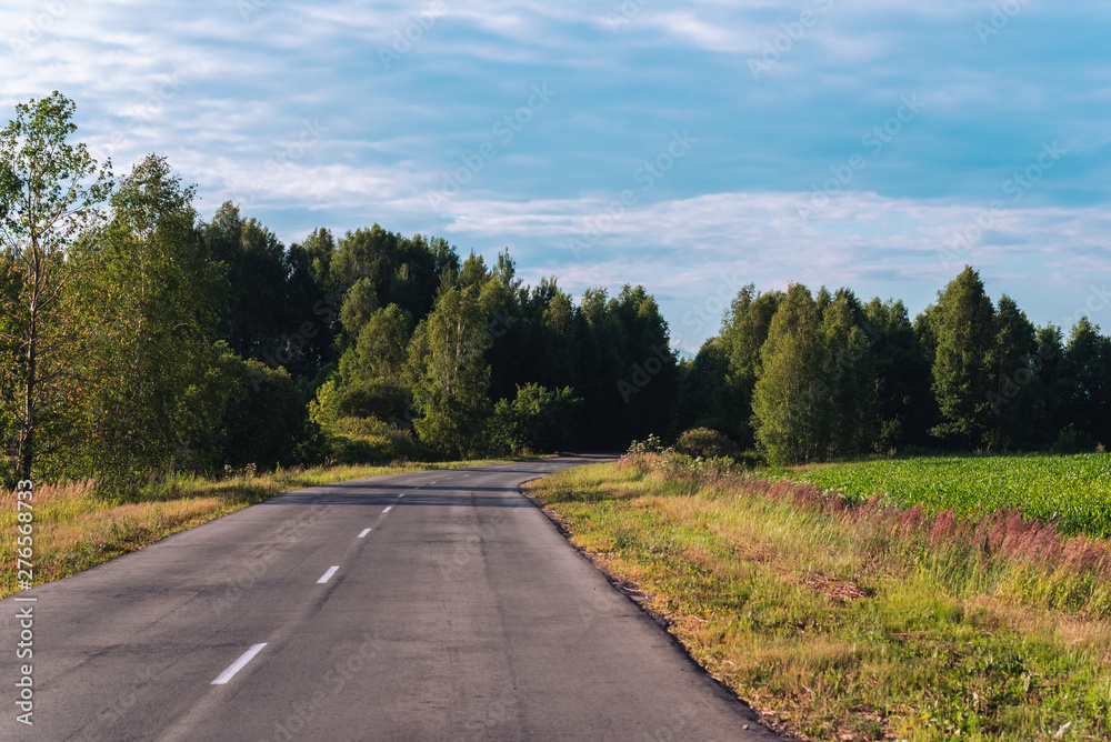 Perfectly smooth asphalt road in the countryside before sunset