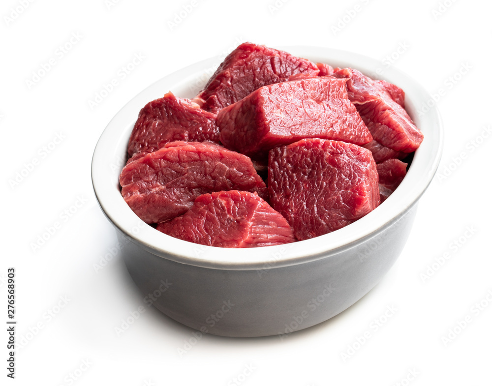 Sliced raw beef in ceramic bowl isolated on white Sliced raw beef in ceramic bowl isolated on white