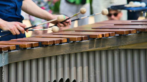 Musician playing on a marimba, an instrument from the group of xylophones photo