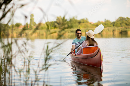 Loving couple rowing on the...