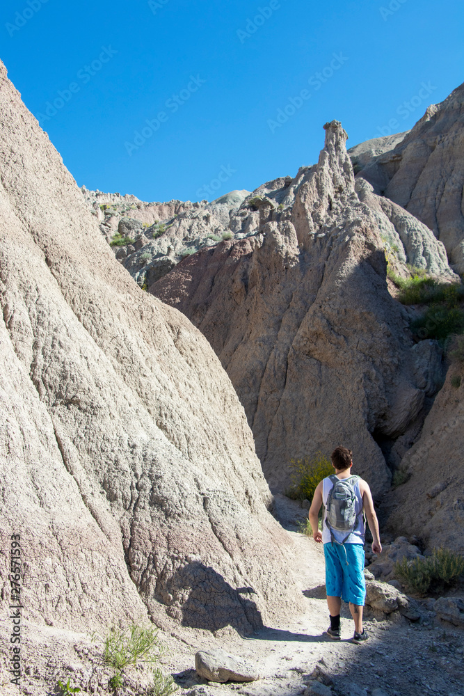 Man Hiking in a Desert Canyon