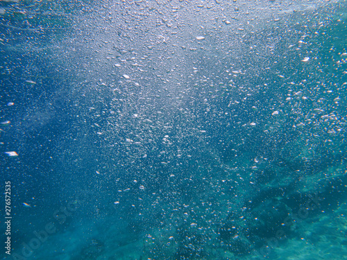 Abstract background of underwater bubbles in the Aponissos beach, Agistri island, Saronic Gulf, Attica, Greece.