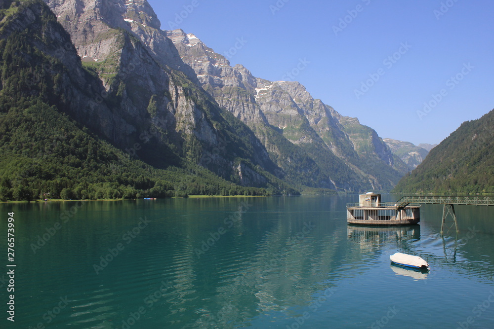 Mountains of the Glaernisch range and clear water of Lake Kloental, Switzerland.