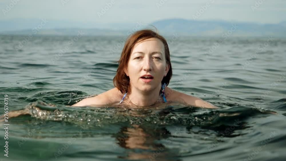 Young tourist woman swimming in Mediterranean sea, diving into water. Greece. Slow motion. HD Young tourist woman swimming in Mediterranean sea, diving into water. Greece. Slow motion. HD