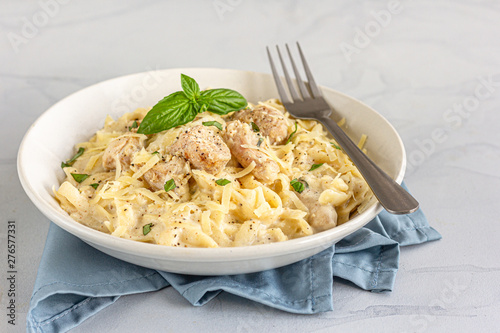 Chicken Alfredo Pasta in a White Bowl High Angle Photo.