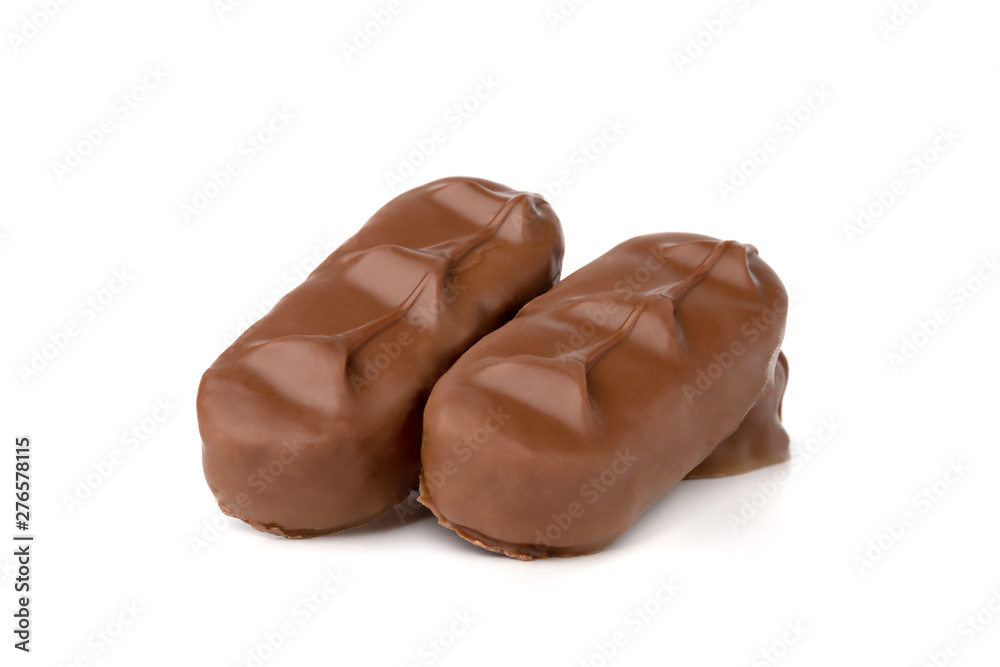 Chocolate bars on a white background. Chocolate candies with coconut flakes close-up. Chocolate bars on a white background. Chocolate candies with coconut flakes close-up.