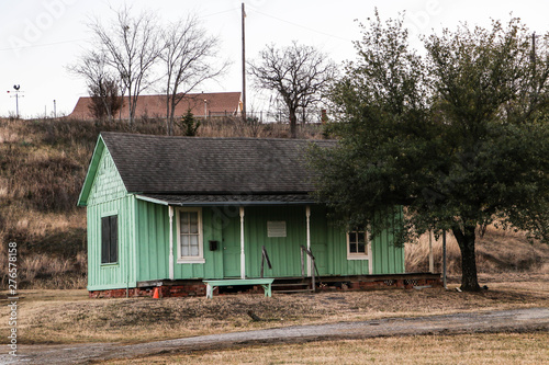 Old green farm house on a hill