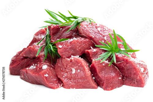 Sliced raw beef with tarragon herb isolated on white