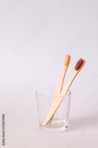 Bamboo toothbrush on blue background. Zero waste, ecological concept.