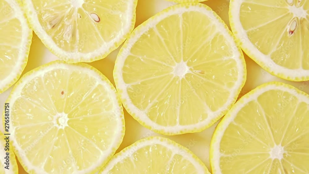 Fruits pattern, close shot. Rotative background. Yellow lemon slices, abstract background. Lemon slices structure. Art installation of fresh juicy fruits cutted into slices Fruits pattern, close shot. Rotative background. Yellow lemon slices, abstract background. Lemon slices structure. Art installation of fresh juicy fruits cutted into slices