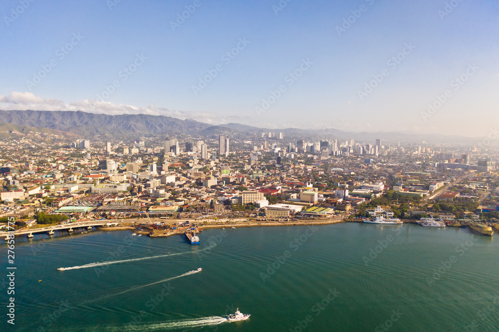 Cityscape in the morning. Streets and seaport of the city of Cebu, Philippines, top view. Panorama of the city with houses and business centers.