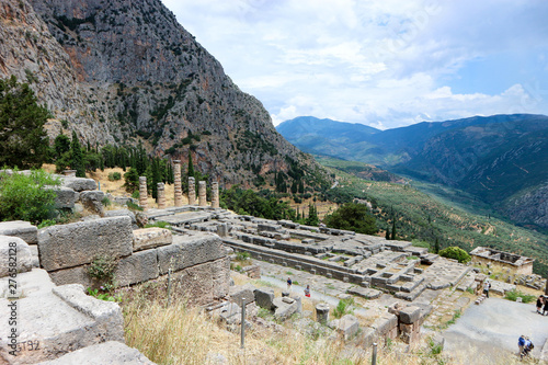 Scenic panoramic view from the top to ruins of ancient greek temple of apollo in Delphi, Greece and Pleistos river valley and parnassus mountain