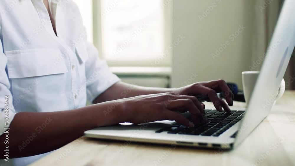 Young asian woman with laptop sitting at the desk indoors at home, typing. Young asian woman with laptop sitting at the desk indoors at home, typing.