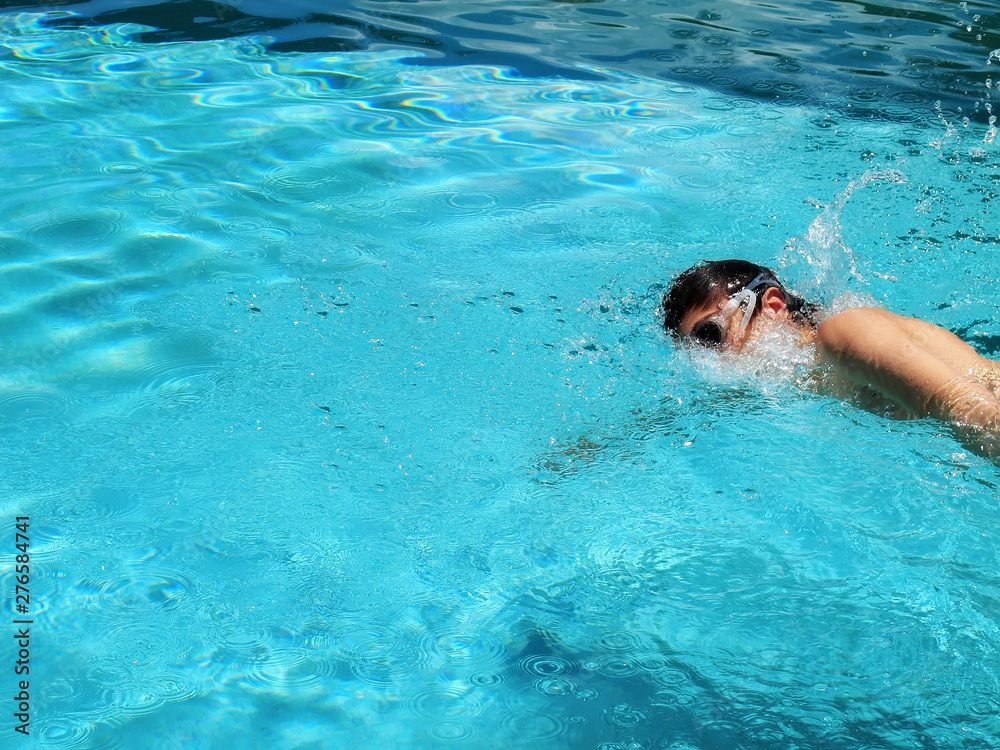 close up teenager boy swimming at swimming pool