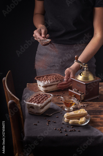 girl preparing tiramisu dessert on the kitchen table