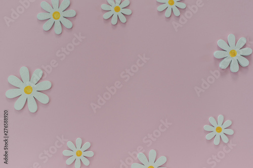 Beautiful pink background with daisies. Texture for creative ideas. The concept of lightness and minimalism in design