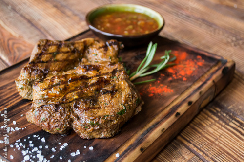 Grilled meat on a wooden table.