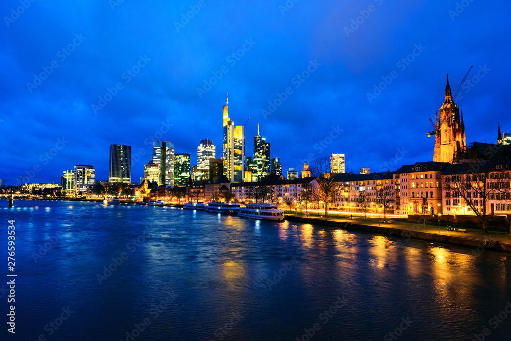 Skyline of Frankfurt, Germany in the sunset with famous illuminated skyscrapers