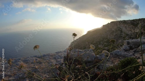 Fawwara cliff on majestic sunrise. Beautiful view over the mediterranean sea and vivid horizon, colorful sky with cloud formations timelapse photo