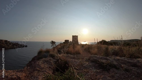 Ghajn Tuffieha Watch Tower on a summer evening, majestic sunset timelapse photo