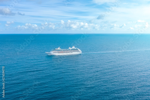 Cruise ship liner sails in the blue sea leaving a plume, seascape. Aerial view The concept of sea travel, cruises.