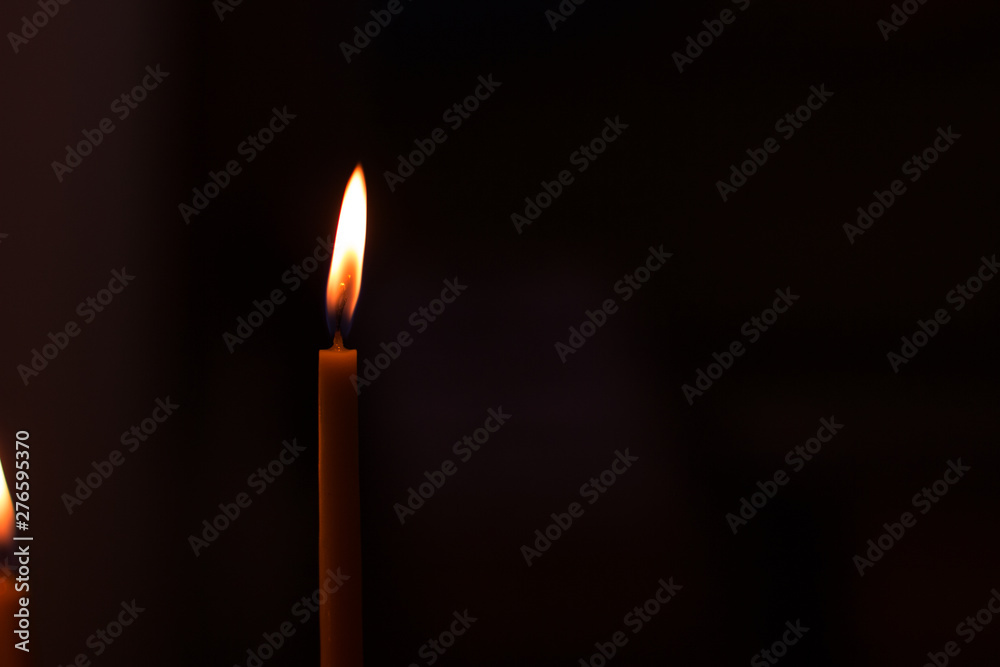 soft focus candle fire illumination in black background, atmospheric wallpaper pattern picture with empty copy space for text