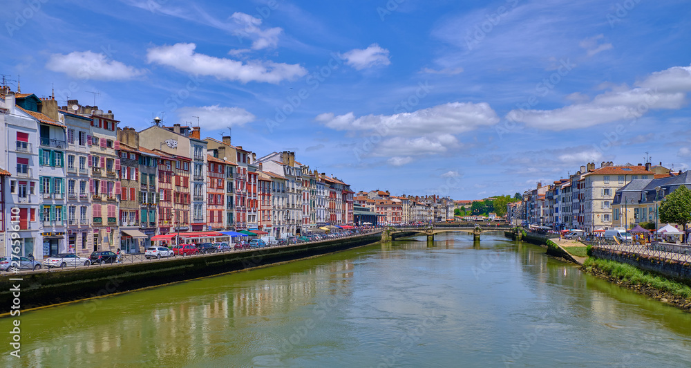View of Nive River and typical basque architecture on houses each side.  Bayonne, France June 2019