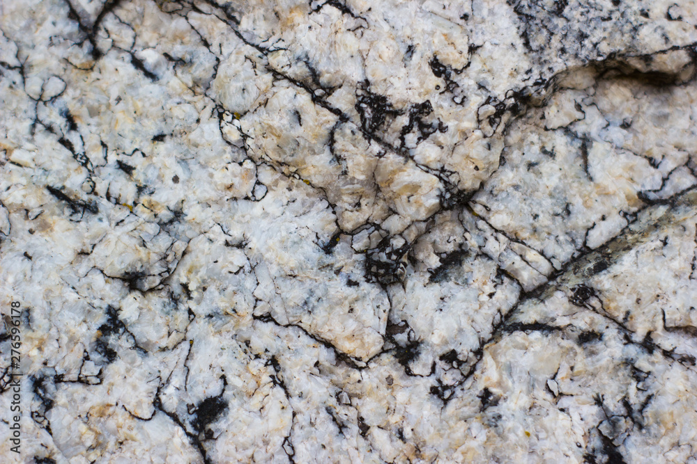 The texture of the granite surface of the stones - stone background The texture of the granite surface of the stones - stone background