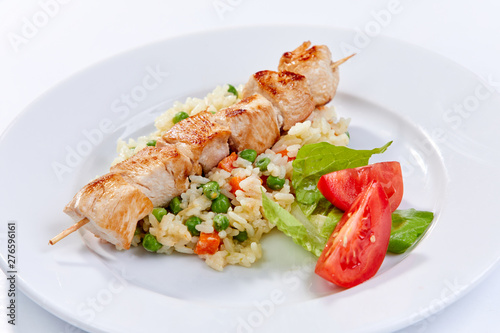 chicken kebab with rice and vegetables