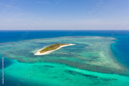 Tropical island Canimeran with sandy beach in the blue sea with coral reef, top view. Balabac, Palawan, Philippines. Small island with palm trees and white sand.