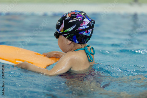 Little girl with float board in the swimming pool © Tatiana Foxy