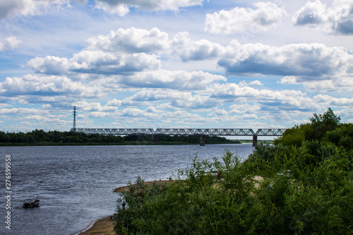 Summer landscape on the Oka river in Murom, Russia with a railway bridge