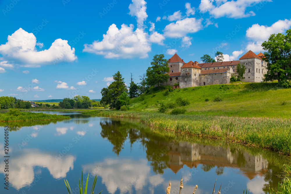 Old beautiful Svirzh castle, surrounded by lake . Ukraine