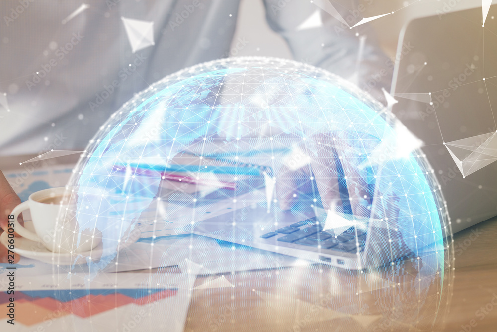 Double exposure of businessman working on laptop on background. International business hologram in front. Concept of success. Double exposure of businessman working on laptop on background. International business hologram in front. Concept of success.