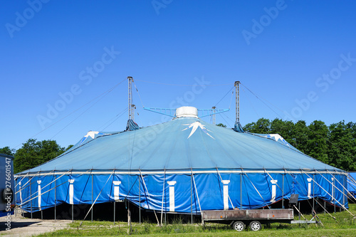 traveling circus blue tent against a blue sky