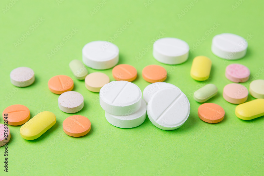 Medicines pills, drugs and antibiotics on a green background. Medicine and health care. Medicines pills, drugs and antibiotics on a green background. Medicine and health care.