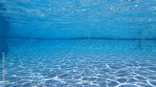 Slow motion underwater sunlight patterns in clean empty swimming pool.  Shot at 240 frames per second.   photo